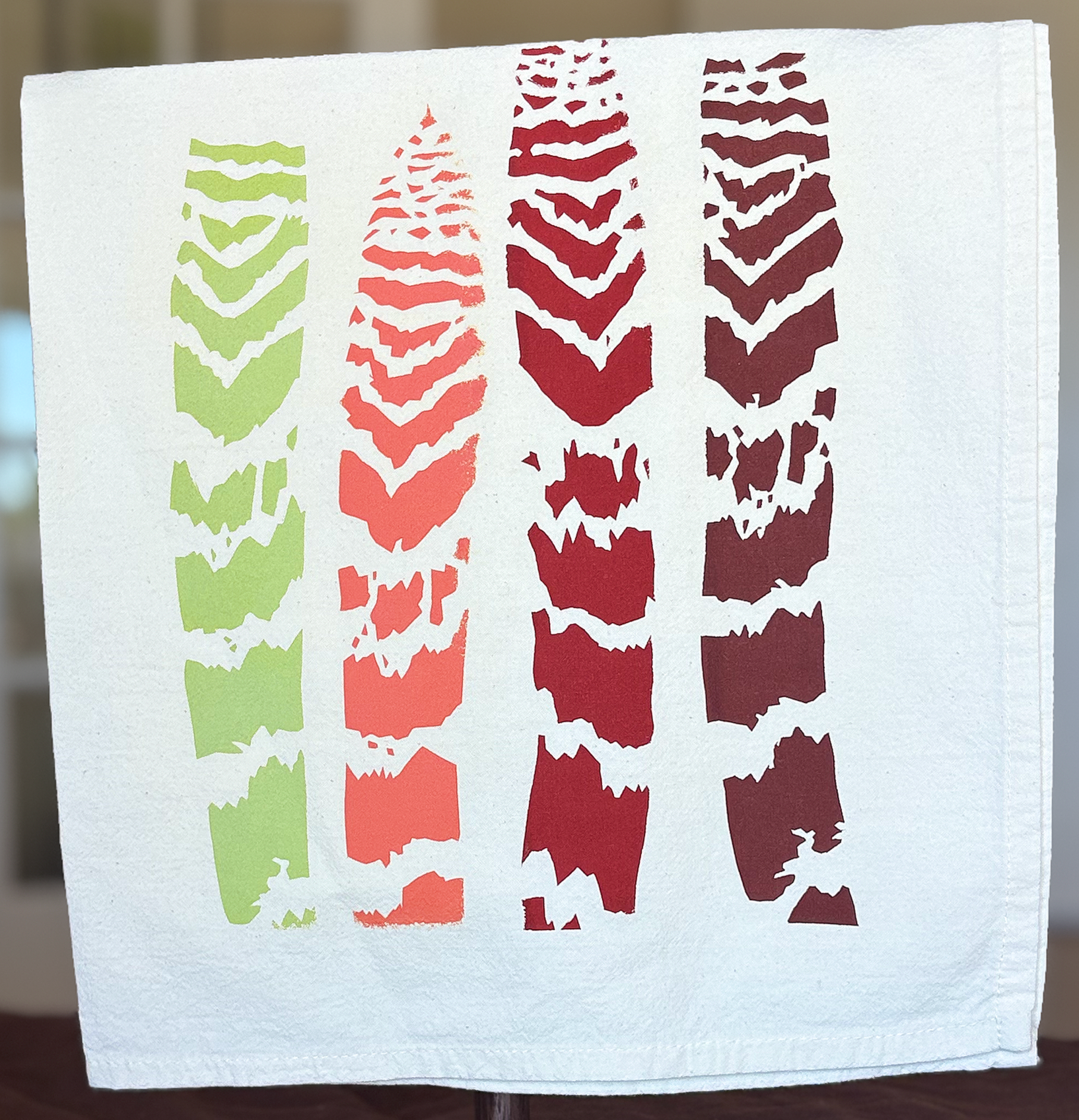 image of cotton tea towel with original Vriesea splendens Flaming Sword bromeliad leaves screen printed design from Handforth Botanical Studio