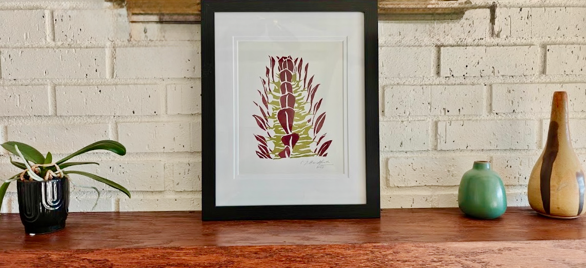 Image of framed original screenprint of Euphorbia trigona rubra in a living room setting