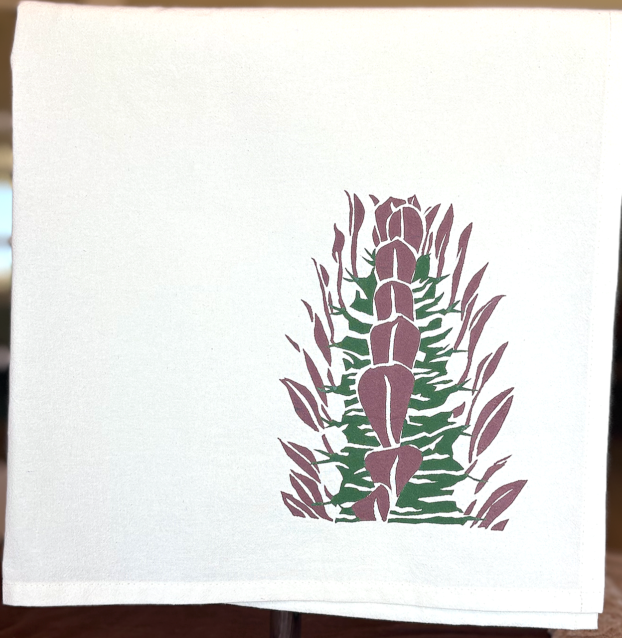 Image of cotton tea towel with original Euphobia trigona 'Rubra' screen printed design from Handforth Botanical Studio