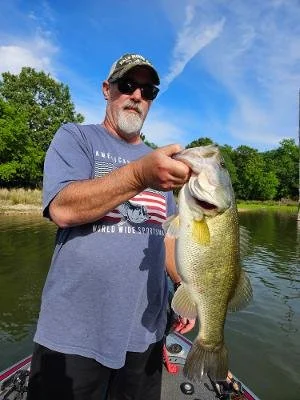 Chuck holding a large-mouth bass he caught on Lake Fork using a Lakeside Lures bait.