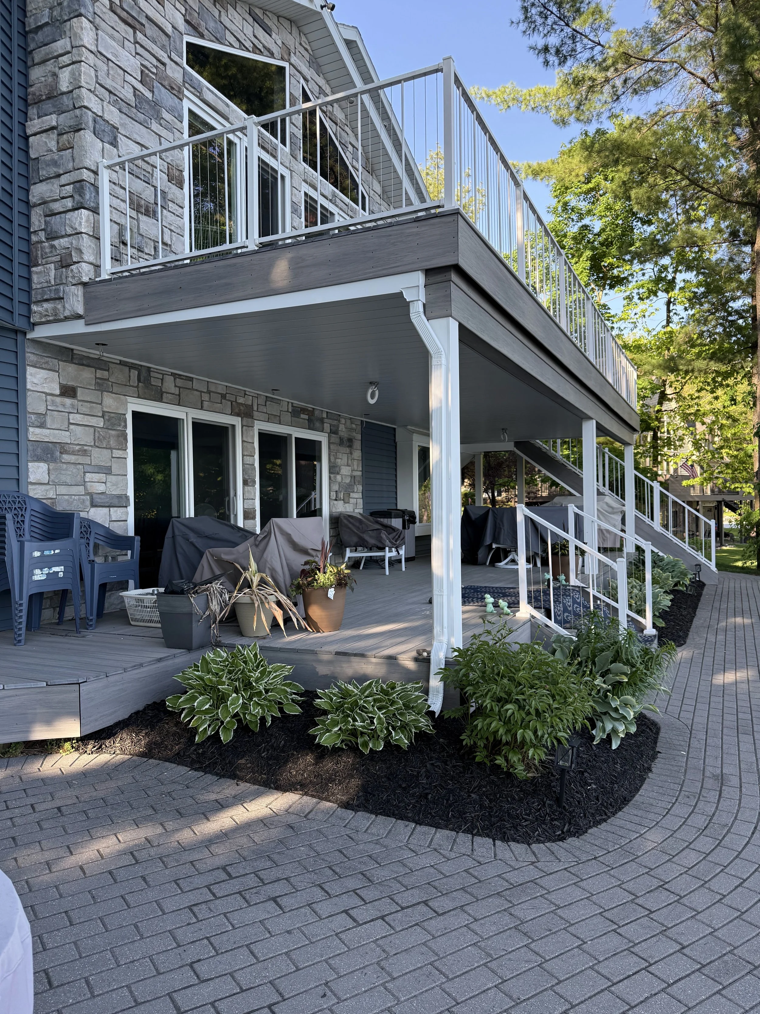 Fresh black mulch and maintained planting beds at a Twin Lake home