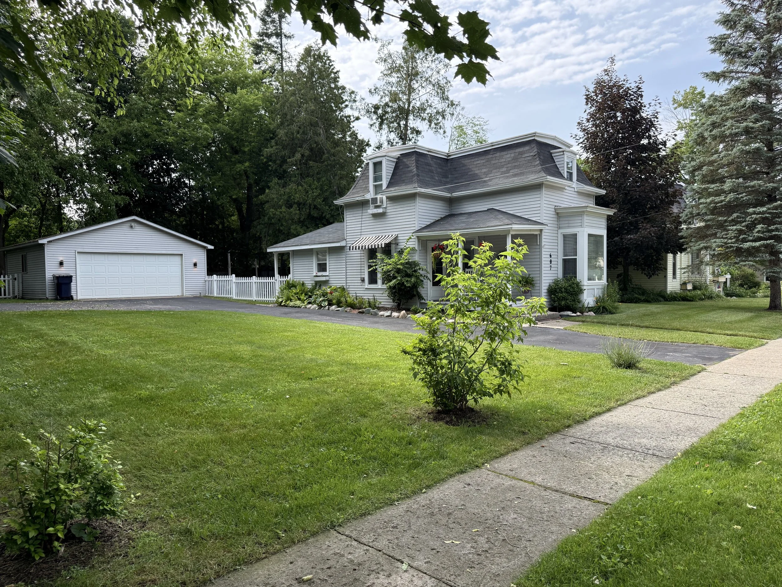 Freshly cut front lawn at a white home in Bellaire, Michigan