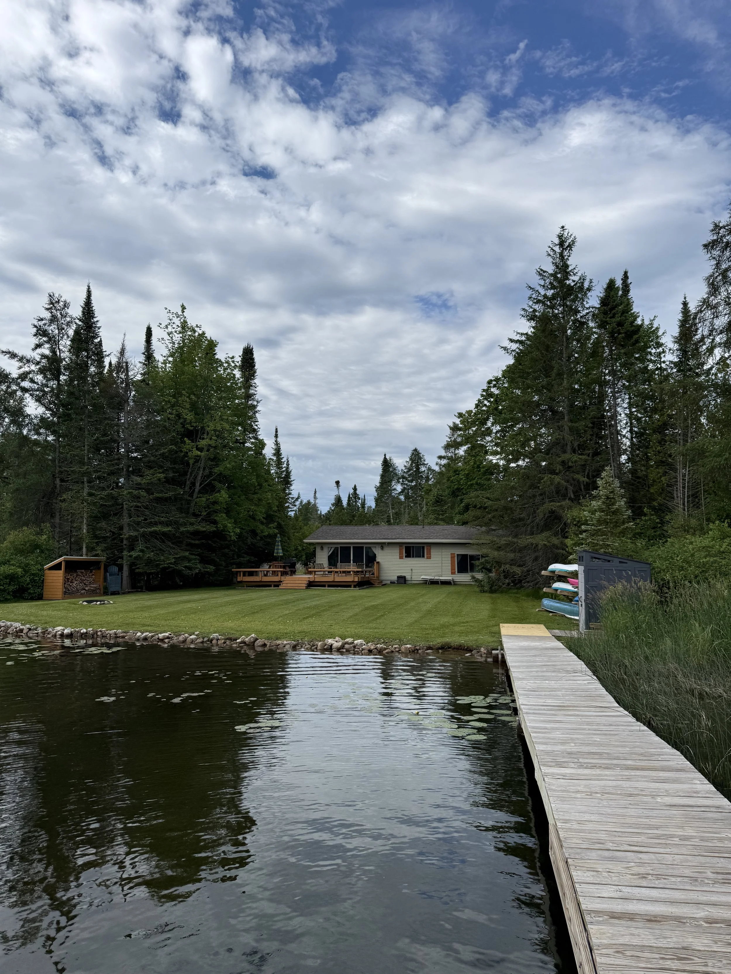 Maintained waterfront lawn beside a dock and home on Clam Lake