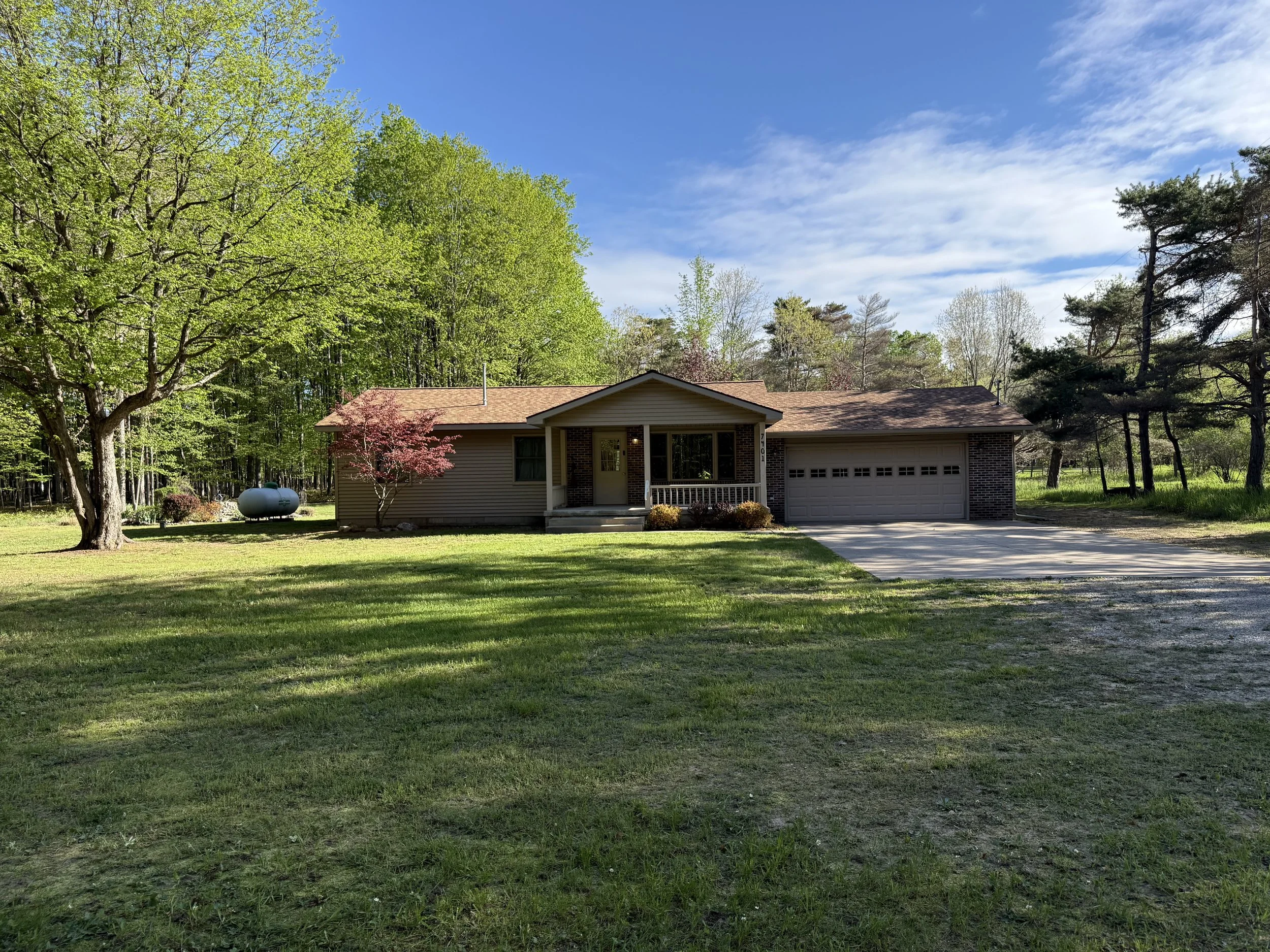 Freshly mowed front lawn at a residential property in Rapid City, Michigan