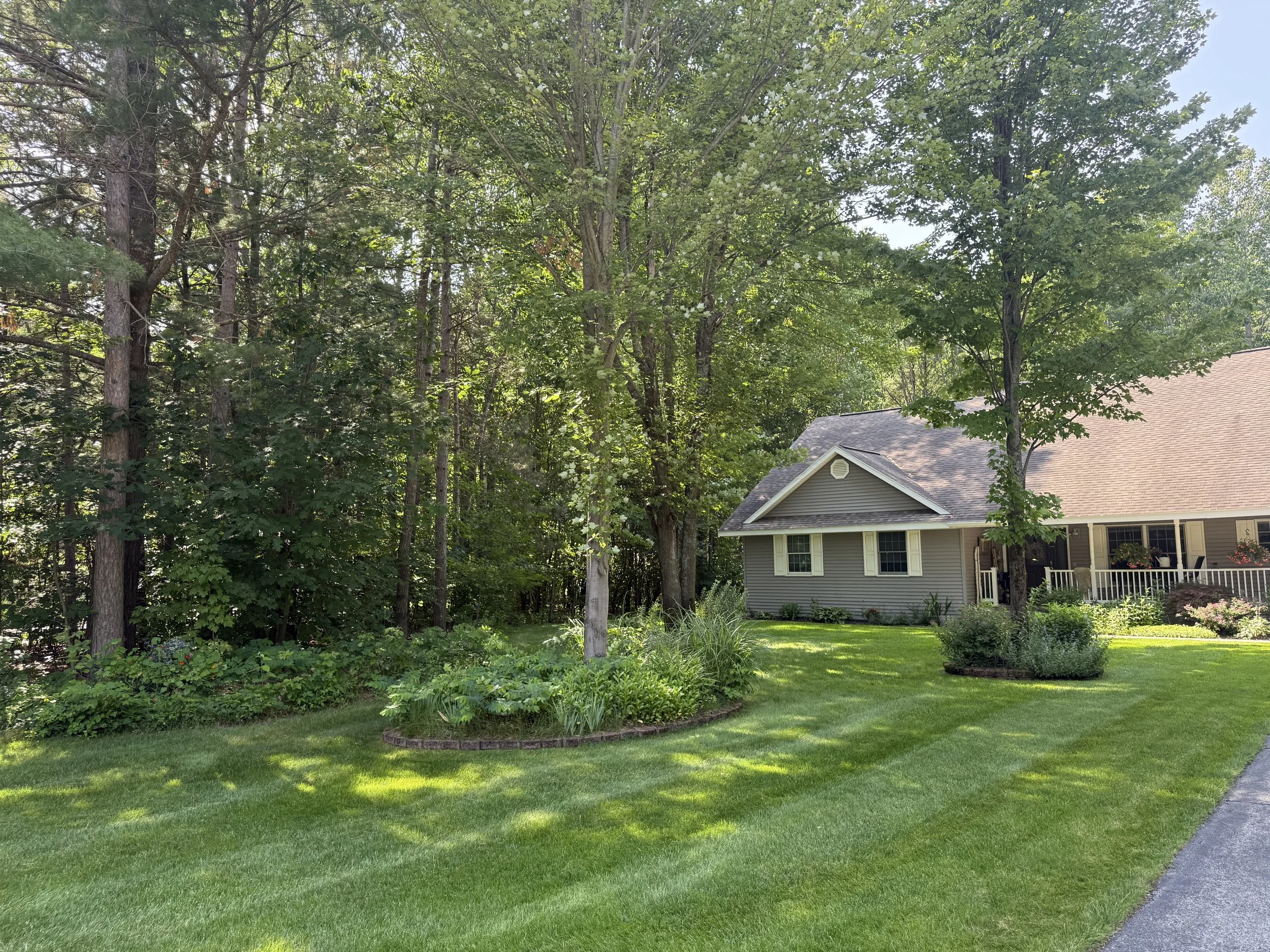 Freshly striped lawn surrounding a wooded home in Kalkaska, Michigan