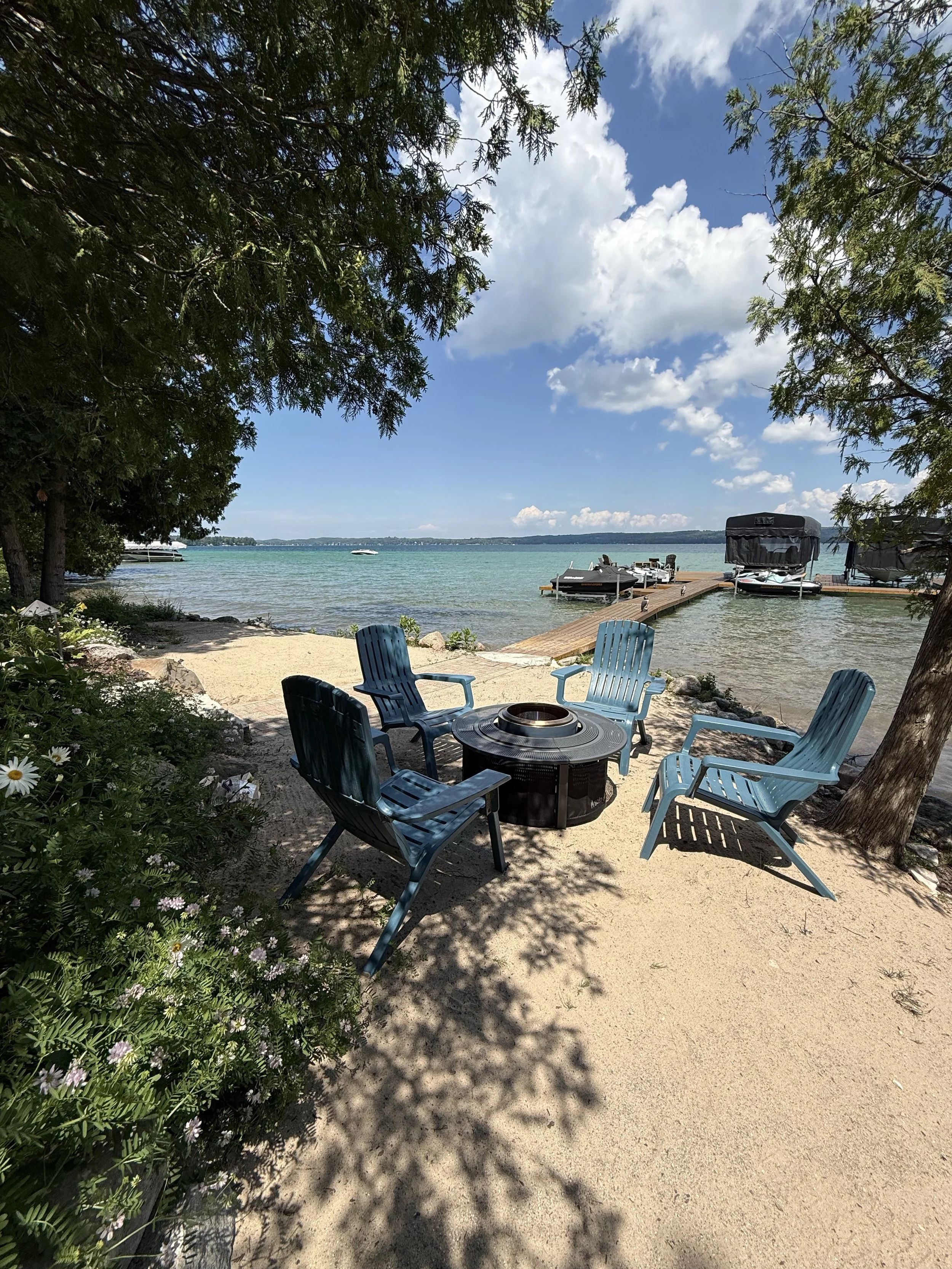 Maintained beach area at a waterfront home on Torch Lake