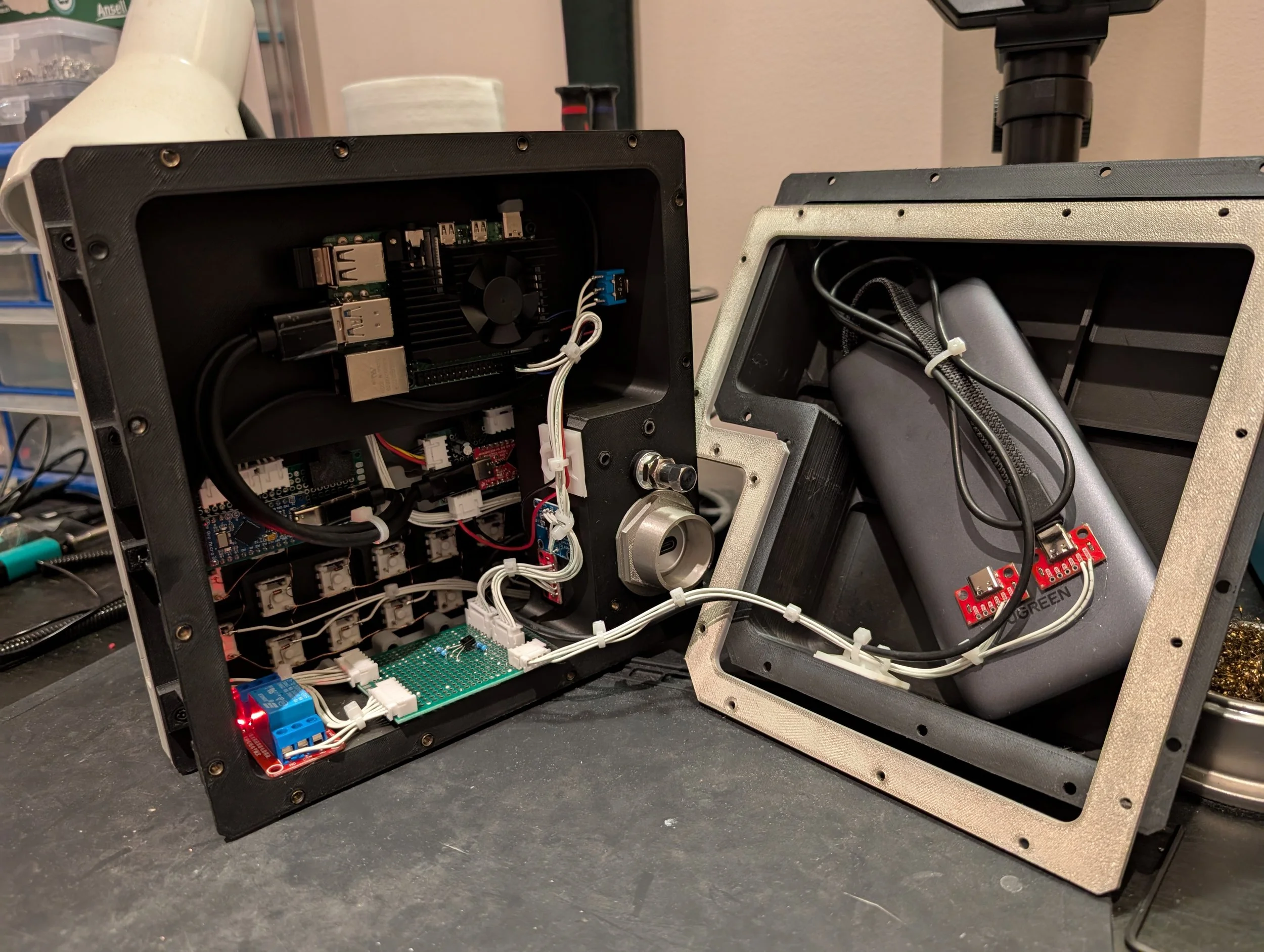 Open computer case with internal components, including circuit boards, wiring, and cooling fans, on a black work surface.