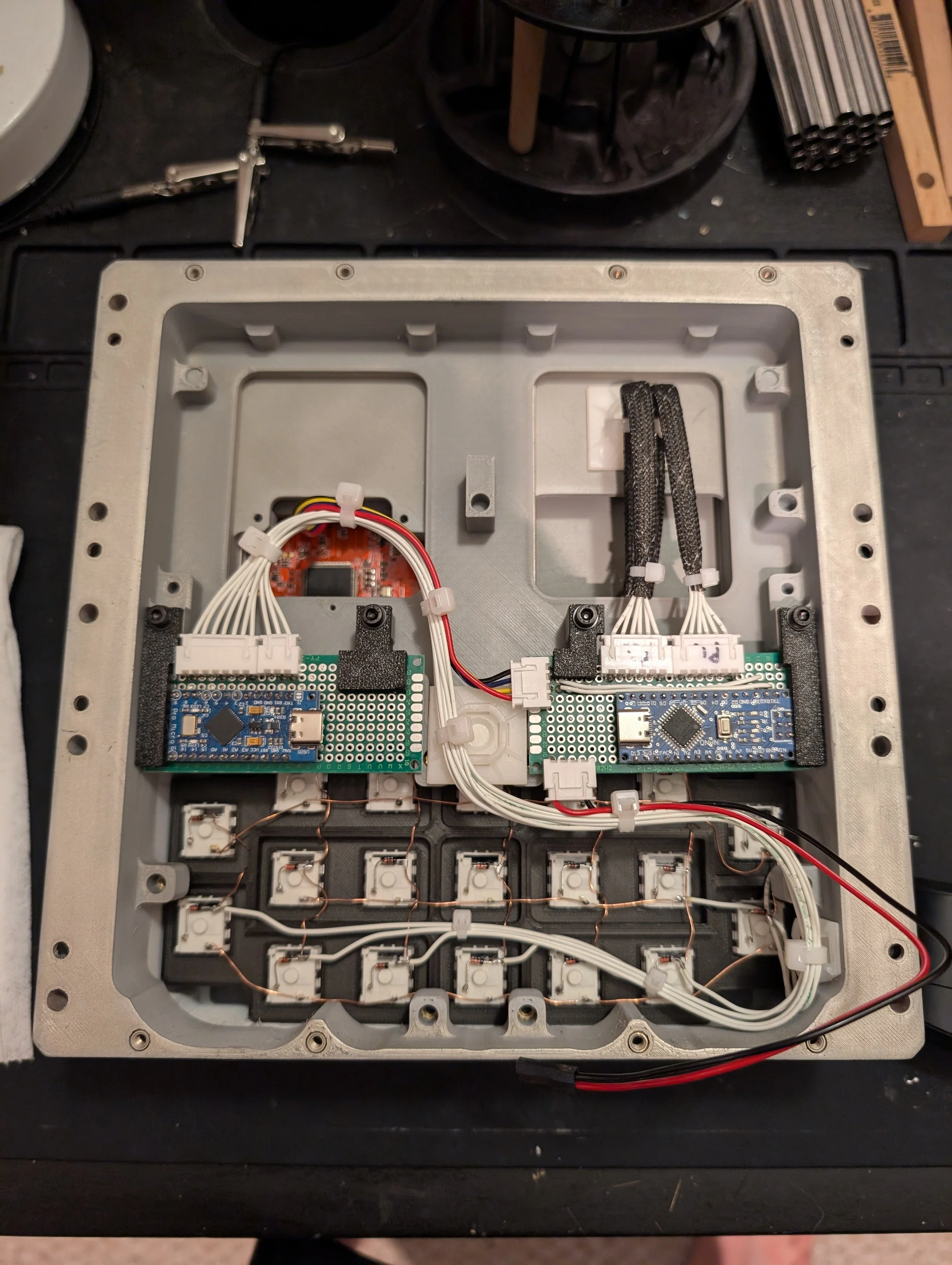 Inside view of an electronic device enclosure with circuit boards, wiring, and various components.