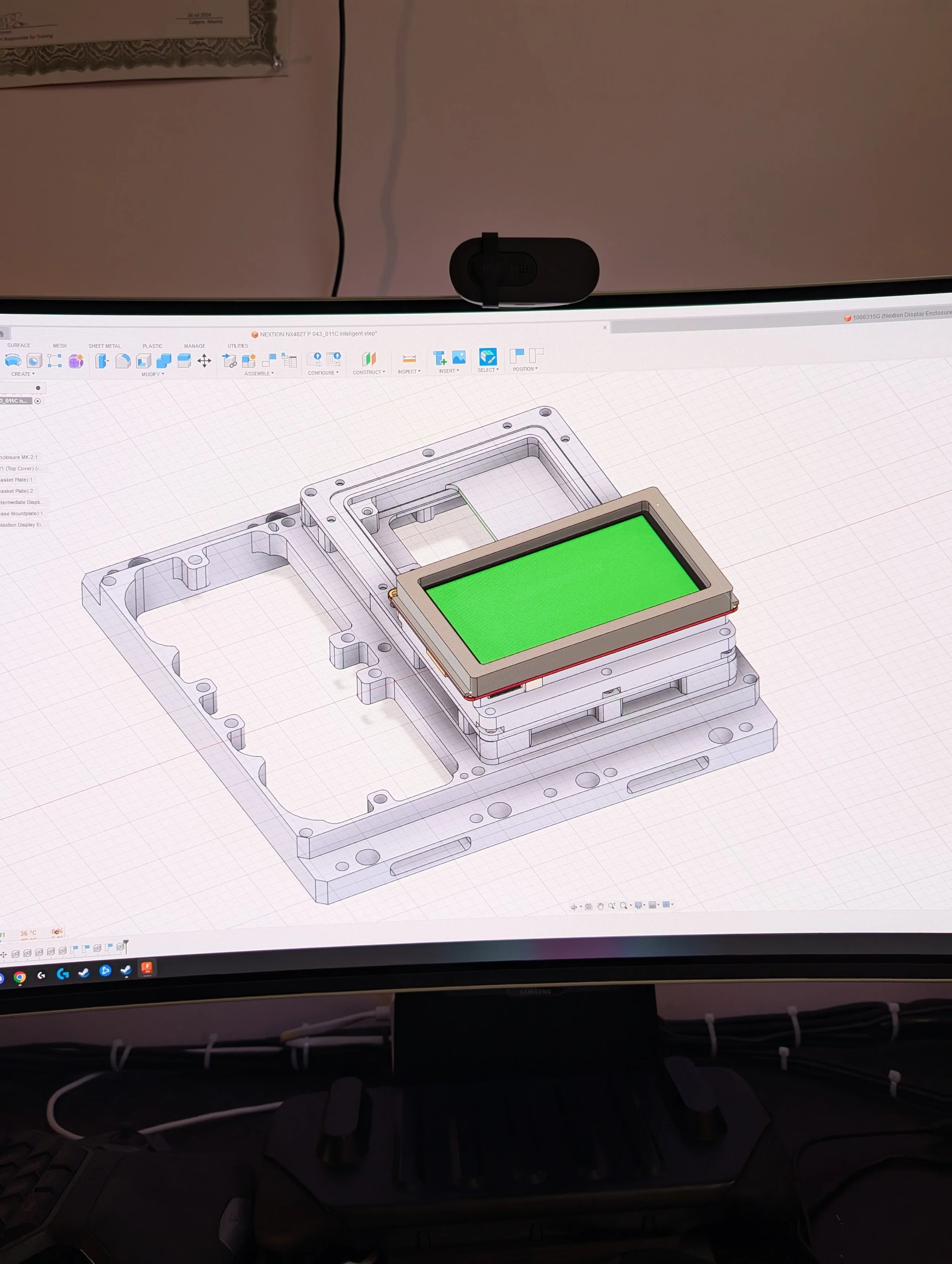 Computer screen displaying 3D design software with a mechanical part and an electronic display attached to it.