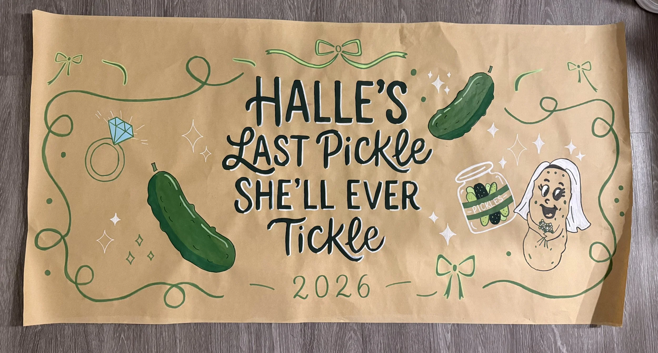 Decorative poster with the quote 'Halle's Last Pickle She'll Ever Tickle,' featuring drawings of pickles, a diamond, a cartoon pickle character, and sports-themed elements, with green borders and bows.