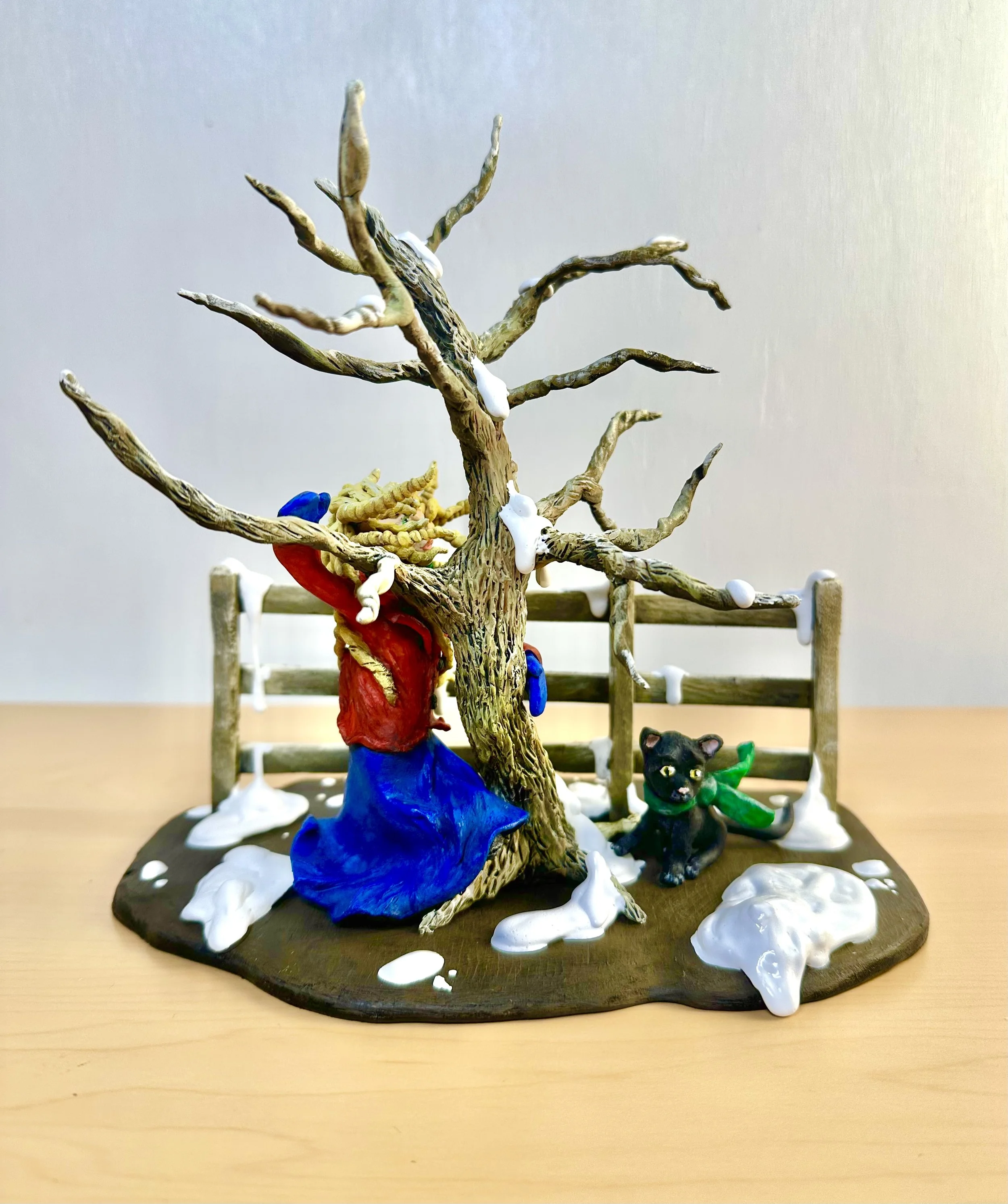 Yellow Blowing Hair Woman Figurine in the Winter Snow with her Black Cat