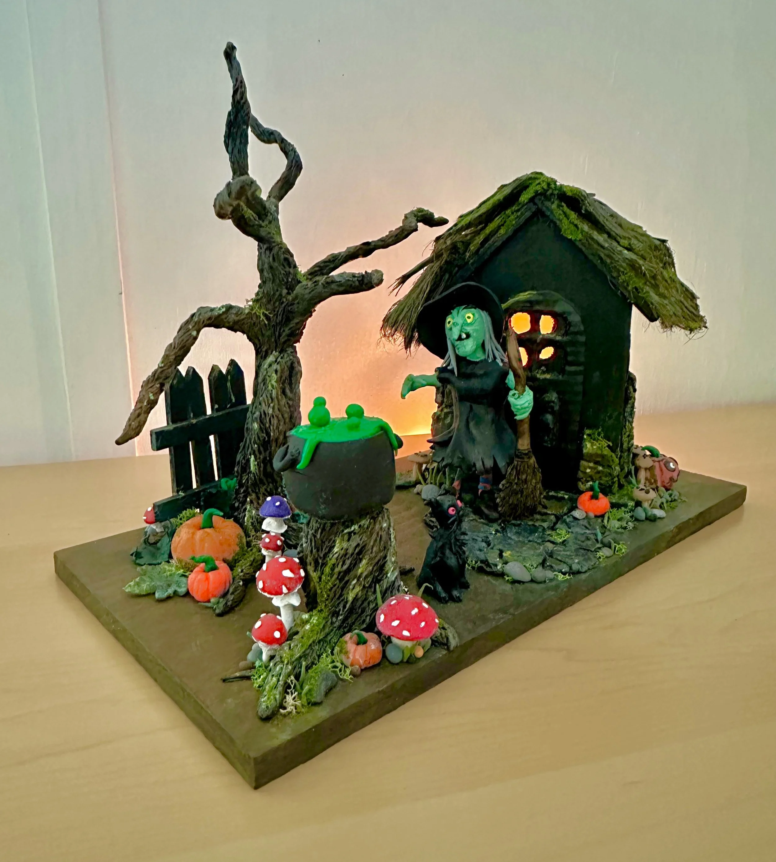 Worried Witch in her Garden with her Boiling Cauldron and her Scary Black Cat