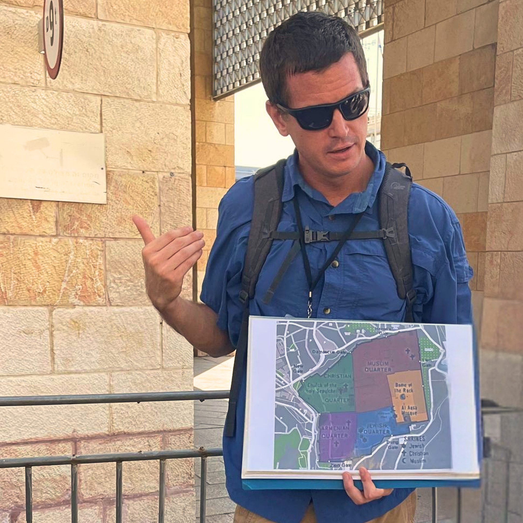 Toon Van Rompay, licensed Holy Land guide and co-founder of Holyland Horizons, holding a neighborhood map at an outdoor location in Israel