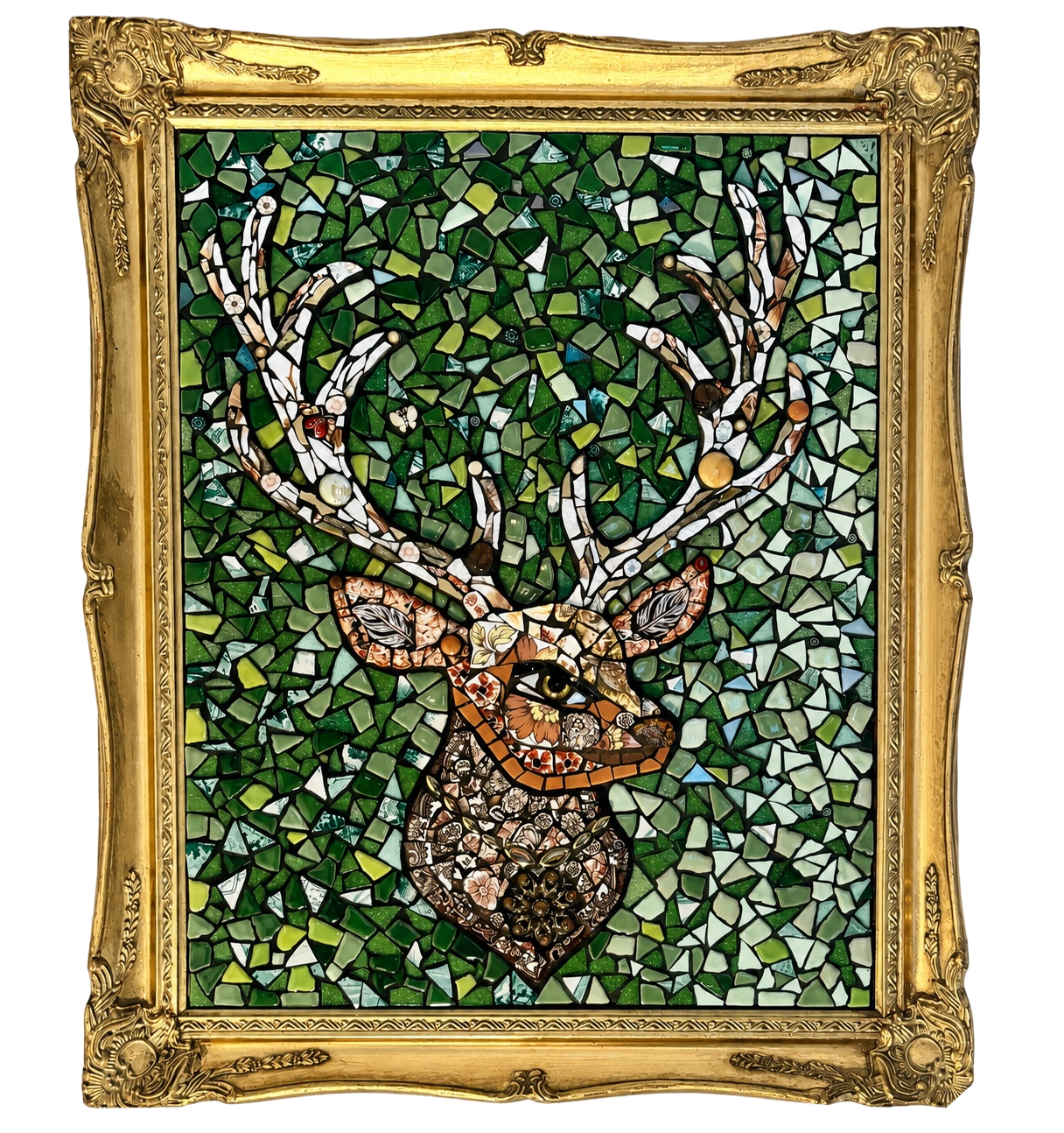 A framed mosaic artwork of a deer with large antlers surrounded by green foliage, made from various colored and shaped pieces of glass or tile.