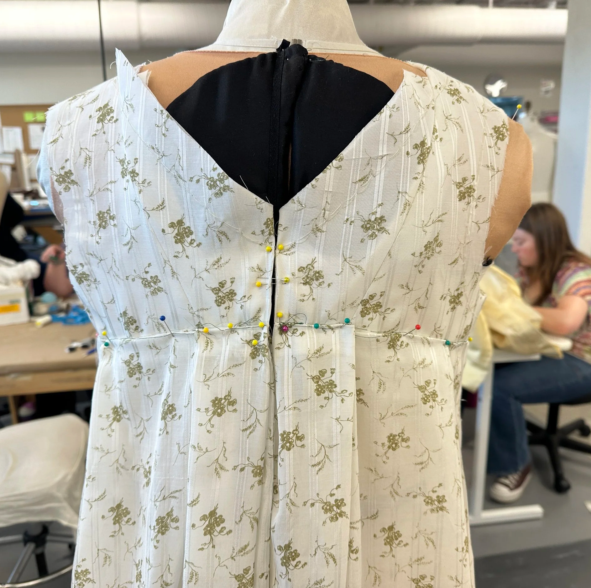 pining box pleats on form according to pattern notches with draper approval
