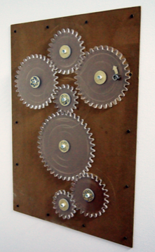 Mechanical gears mounted on a wooden board