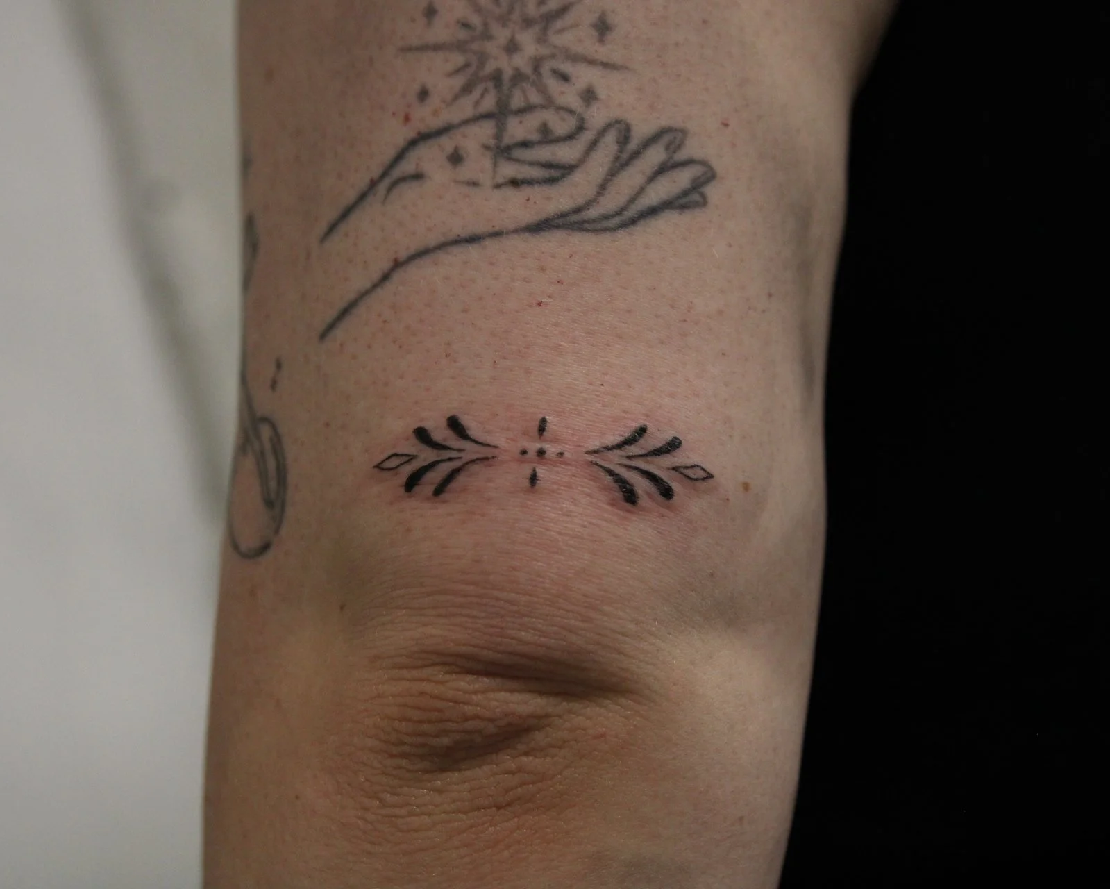 Fine line ornamental tattoo
