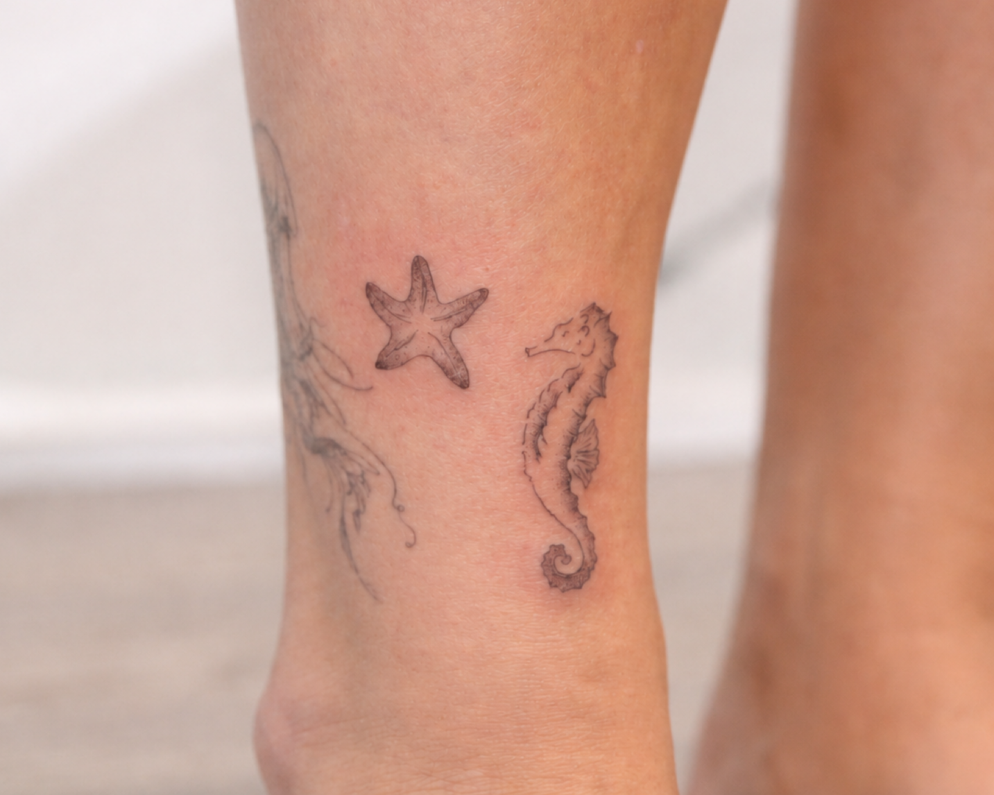 Fine line starfish and seahorse tattoos