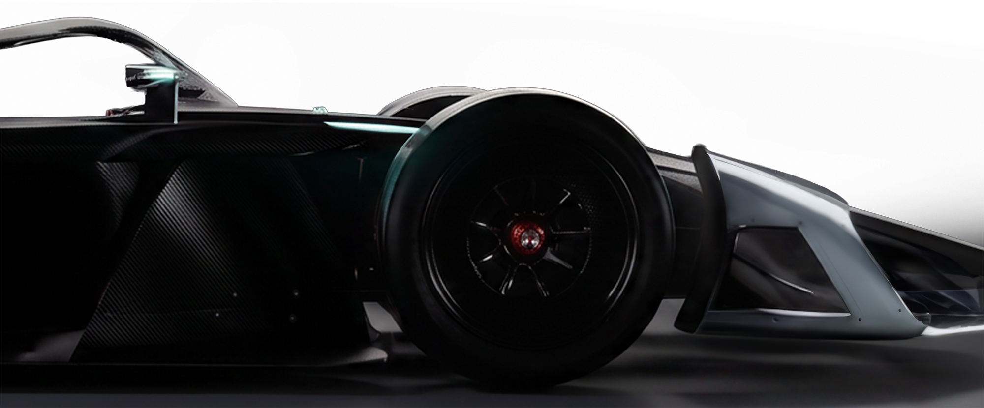 Close-up of the Formula E GEN4 race car wheel and front wing, showcasing sleek design and aerodynamic features.