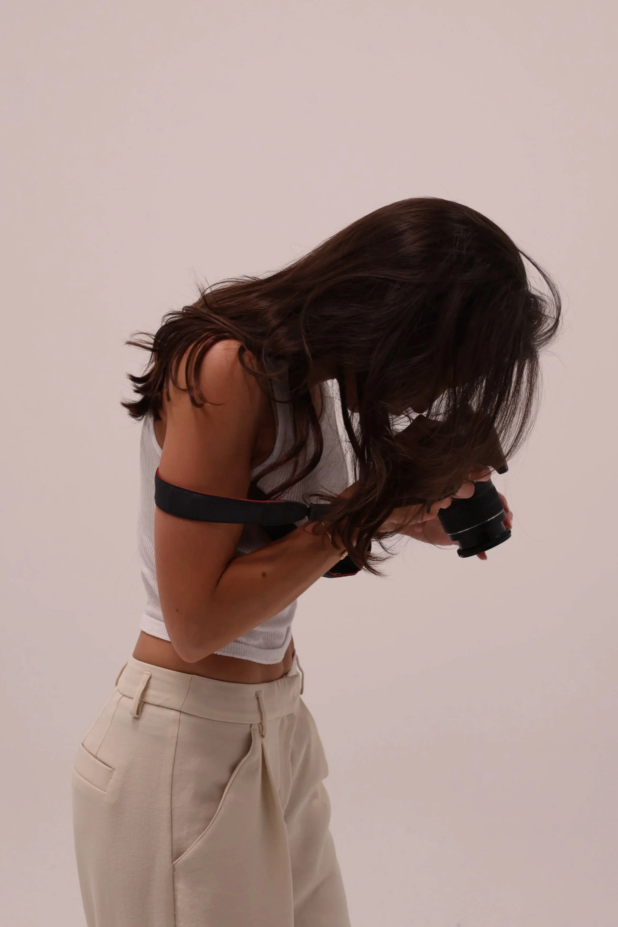 Nikole Réaux, founder of Kolt Following, photographing product  during brand shoot in studio