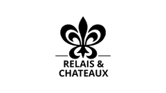 Logo of Relais & Châteaux with a fleur-de-lis symbol and text underneath