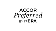 Black silhouette of a whale jumping out of the water against a white background.