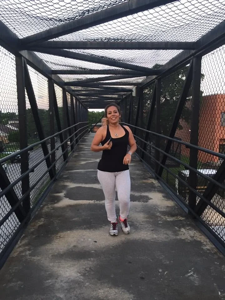 Woman walking through an outdoor training area before a Body By U Fit women's strength training session in Central Houston, building an active and healthy lifestyle.