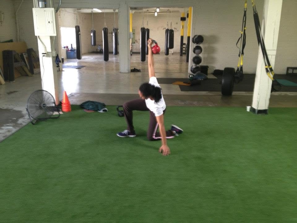 Woman over 40 performing a strength and mobility exercise at Body By U Fit, proving it's never too late to get stronger, healthier, and more confident.