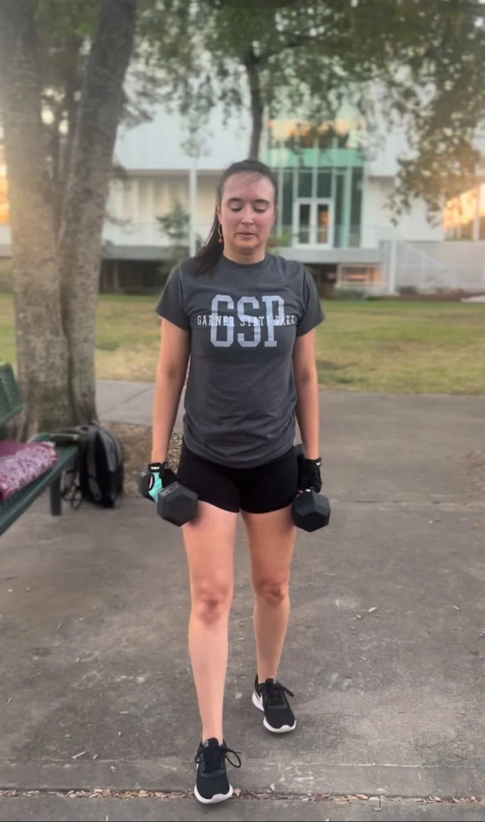 Sara strength training with dumbbells during a Body By U Fit women’s strength training workout in Houston, Texas.
