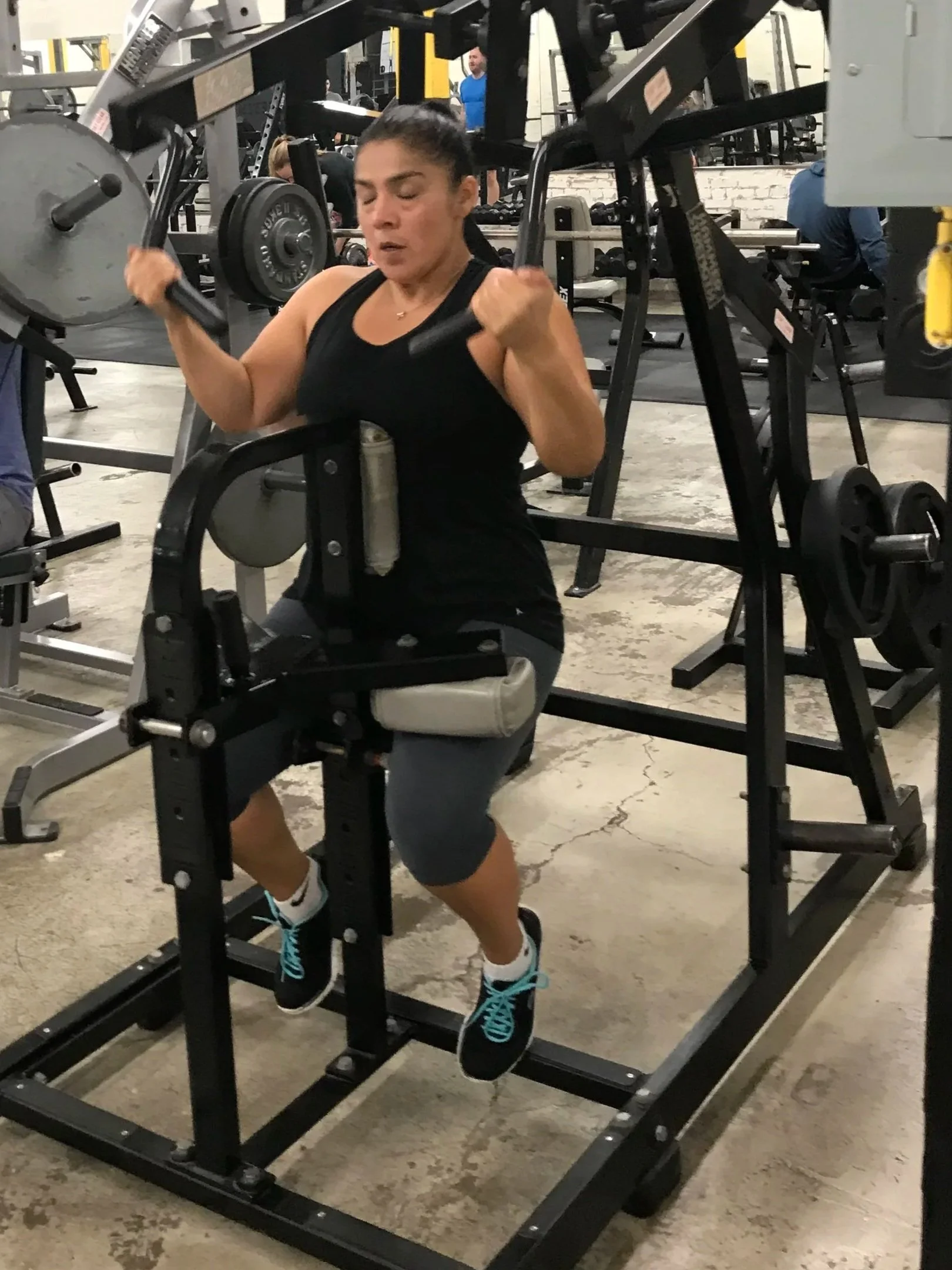 Woman performing a lat pulldown during EmpowerHer 1-on-1 strength training with Body By U Fit in Houston, TX.