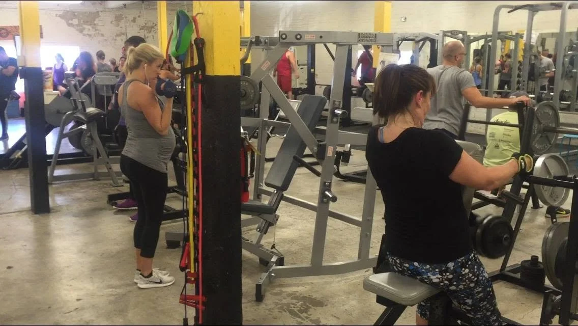 Molly participating in a coached small group strength training session at Body By U Fit in Central Houston, building strength in a supportive women's fitness community.