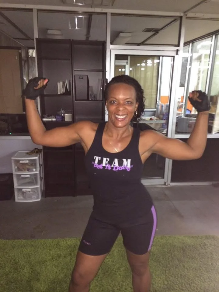 Woman over 40 strength training with dumbbells during a Body By U Fit coached workout in Houston.
