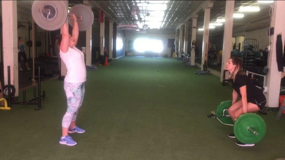 Women training together in a Fit4Her small group strength training session in Central Houston.