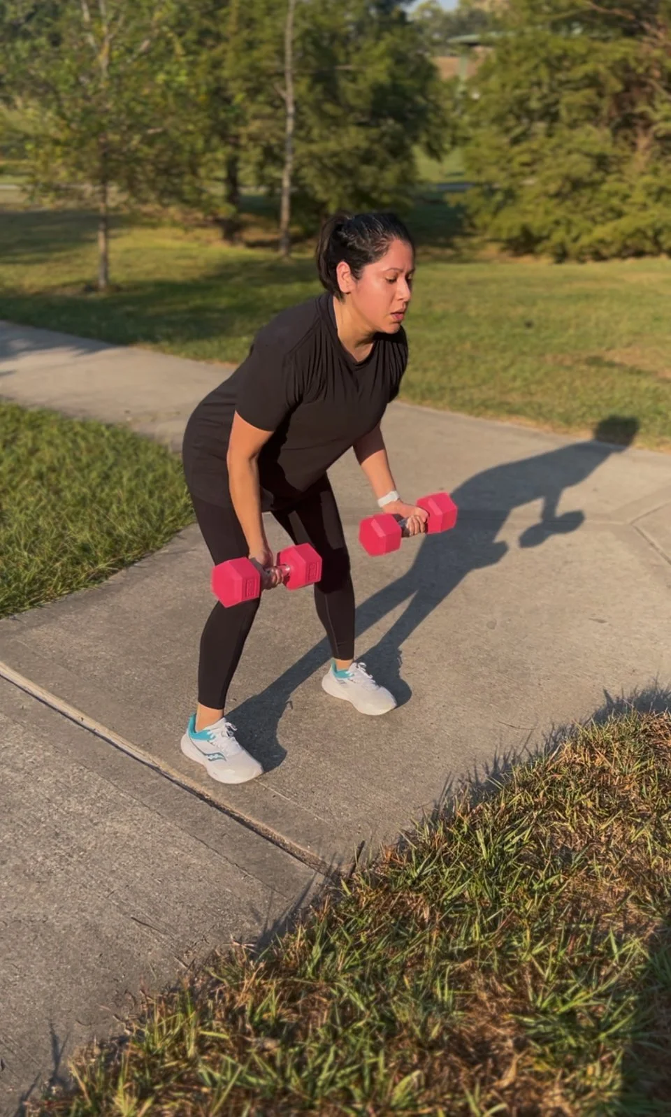 Woman building strength with dumbbells during Body By U Fit women's strength training in Central Houston.