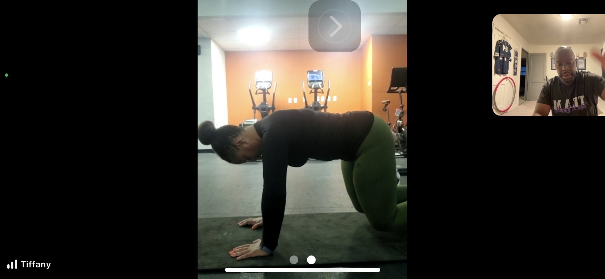 Woman participating in live Fit4Her virtual strength training with Coach Phil from home.