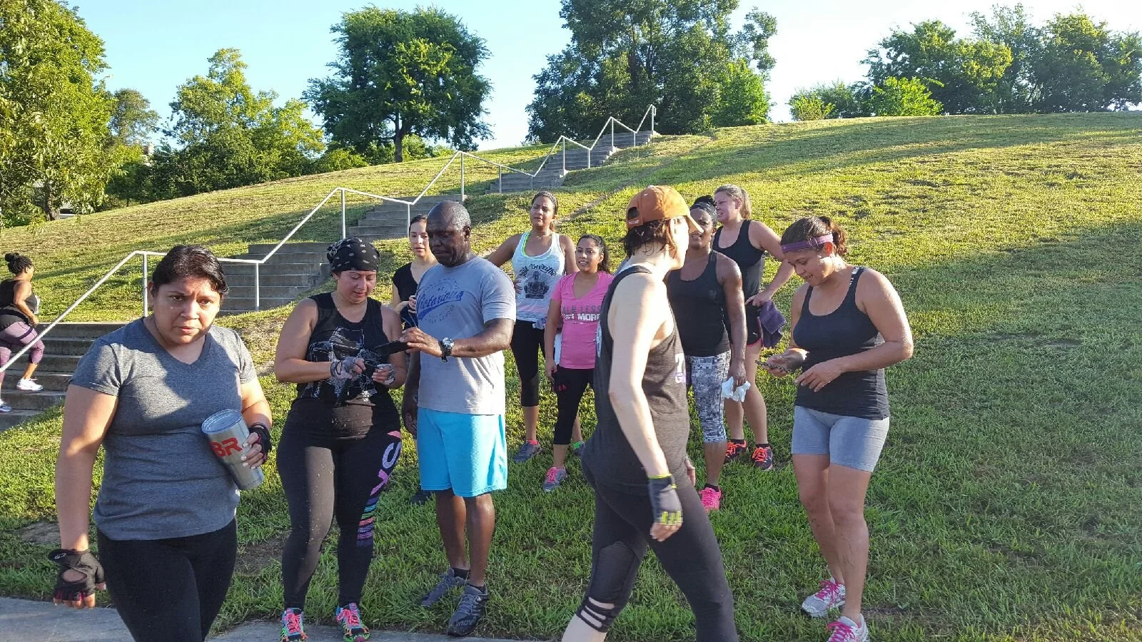 Women participatFit4Her outdoor small group strength training helping women build strength, confidence, and consistency in Central Houston.ing in a Body By U Fit outdoor strength training group workout at Spotts Park in Central Houston, Texas.
