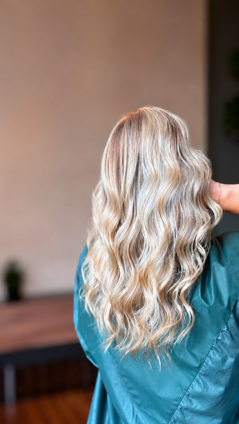 Long dimensional blonde hair with soft waves and cool highlights at The Hair Canvas in Ashland, KY.
