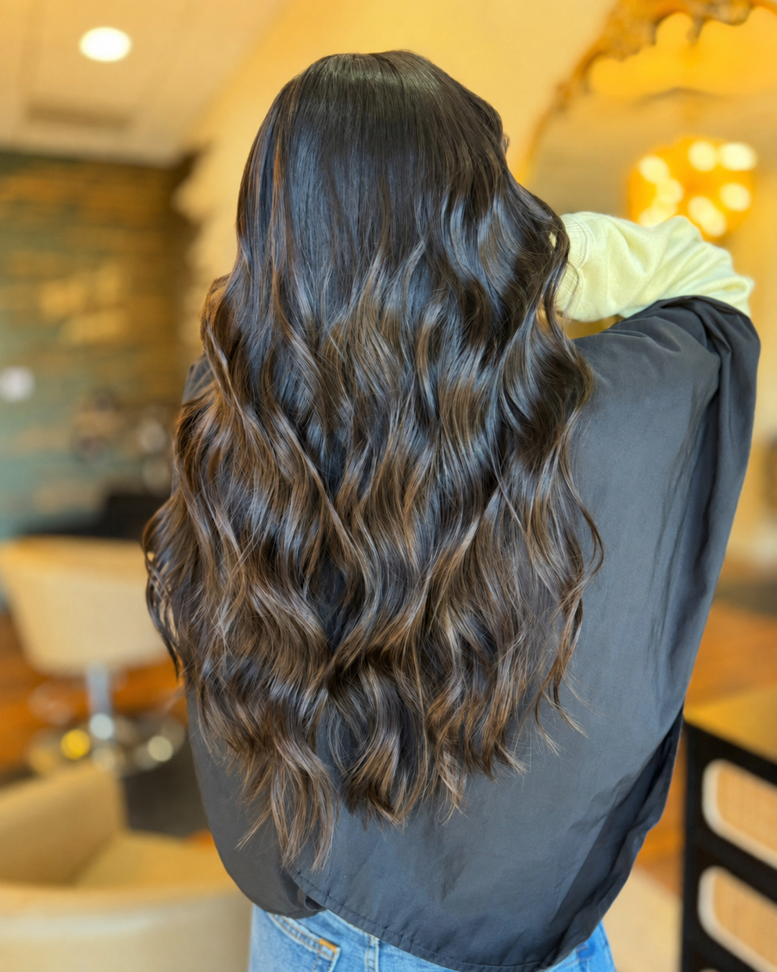 Deep glossy brunette color with long soft waves at The Hair Canvas in Ashland, KY.