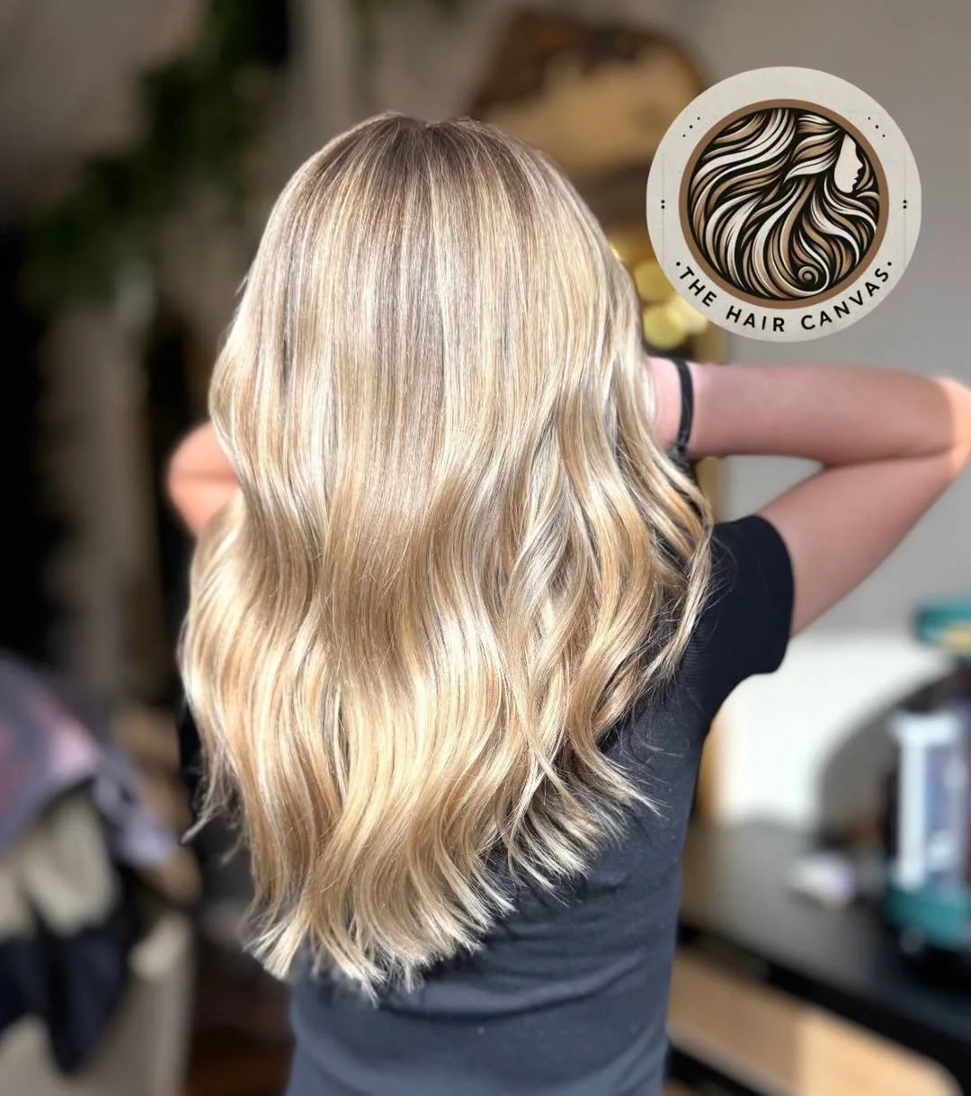Back view of a beautiful young girl with long, wavy blonde hair.