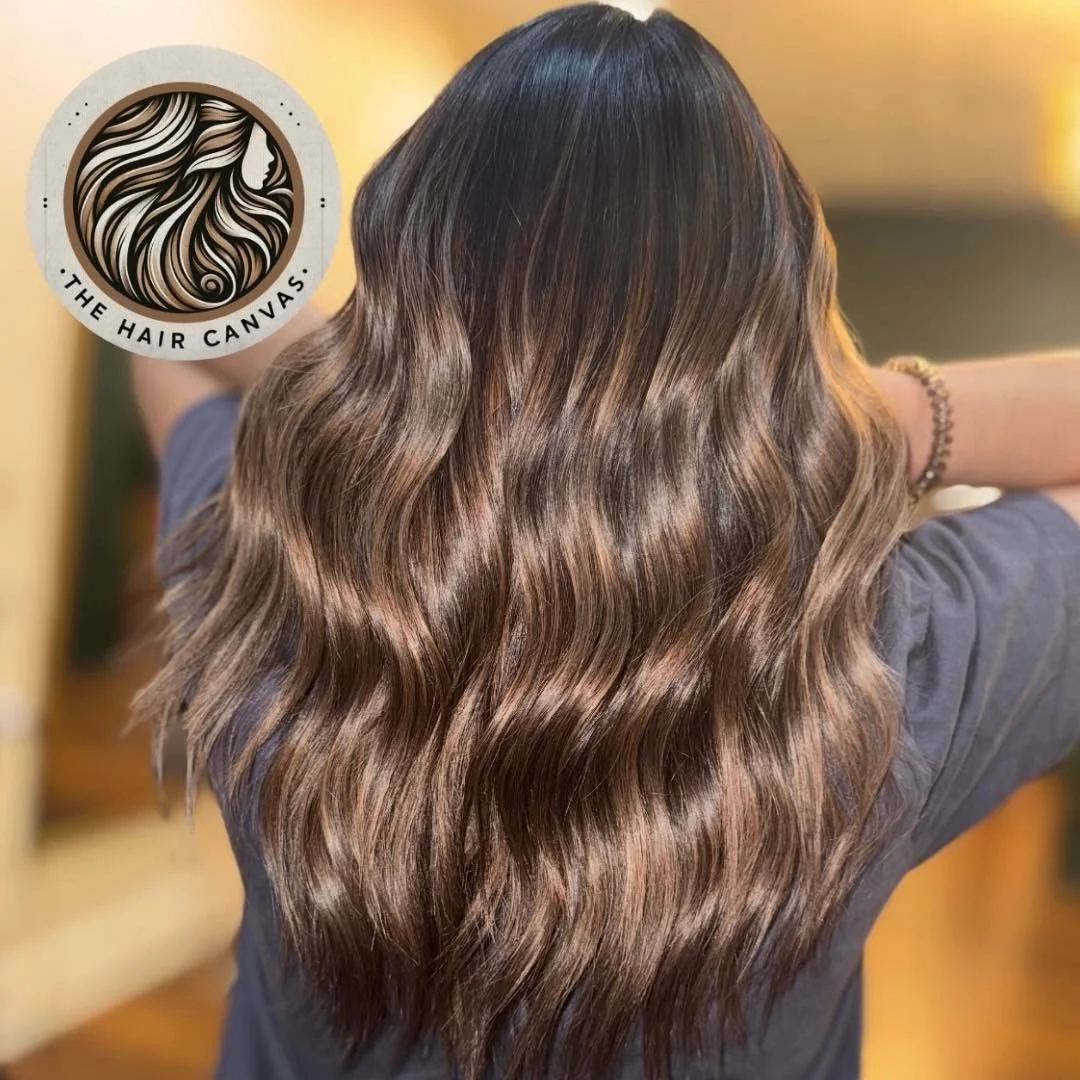 Deep brunette hair color with high-shine waves at The Hair Canvas in Ashland, KY.