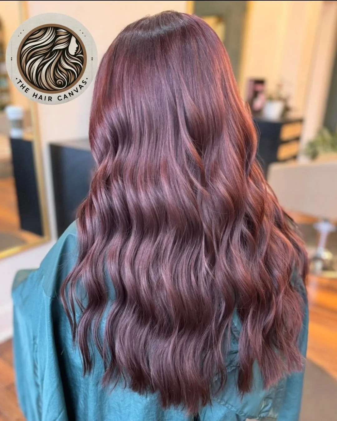 Rich plum auburn hair color with soft waves at The Hair Canvas in Ashland, KY.