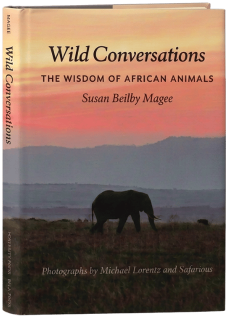A book titled "Wild Conversations: The Wisdom of African Animals" by Susan Beilby Magee with photographs by Michael Lorentz and Safarious, featuring a silhouette of an elephant in a natural landscape at sunset or sunrise.