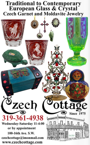 Display of Czech garnet and Moldavite jewelry, European glass and crystal glassware, including a green and purple glass, decanters, and a mosaic box, with promotional information for Zech Cottage, an antique store established in 1975.
