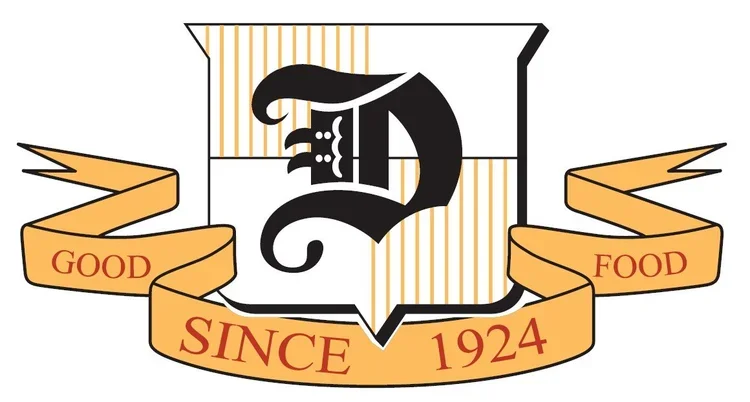 Logo with a central black letter 'D' with a crown on top, surrounded by a shield and an orange ribbon banner that says 'Since 1924' with the words 'Good Food' on either side.
