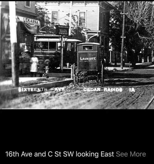 A vintage black and white photo of 16th Avenue and C Street SW in Cedar Rapids, Iowa, showing a street corner with a laundry sign, a streetcar, and pedestrians.