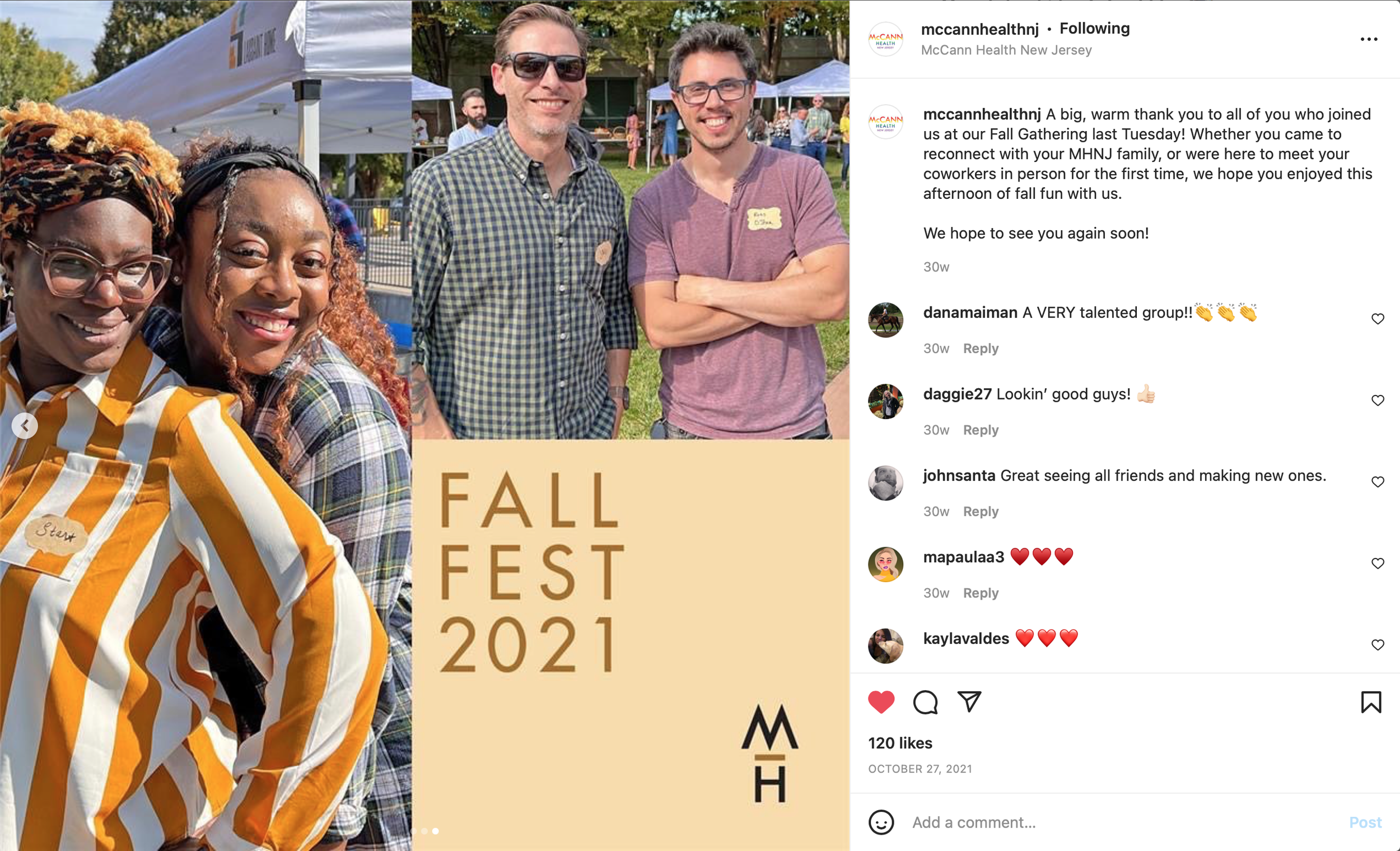 Group of four people smiling at an outdoor fall fest, with tents and other attendees in the background, and a large banner reading 'Fall Fest 2021' in the foreground.