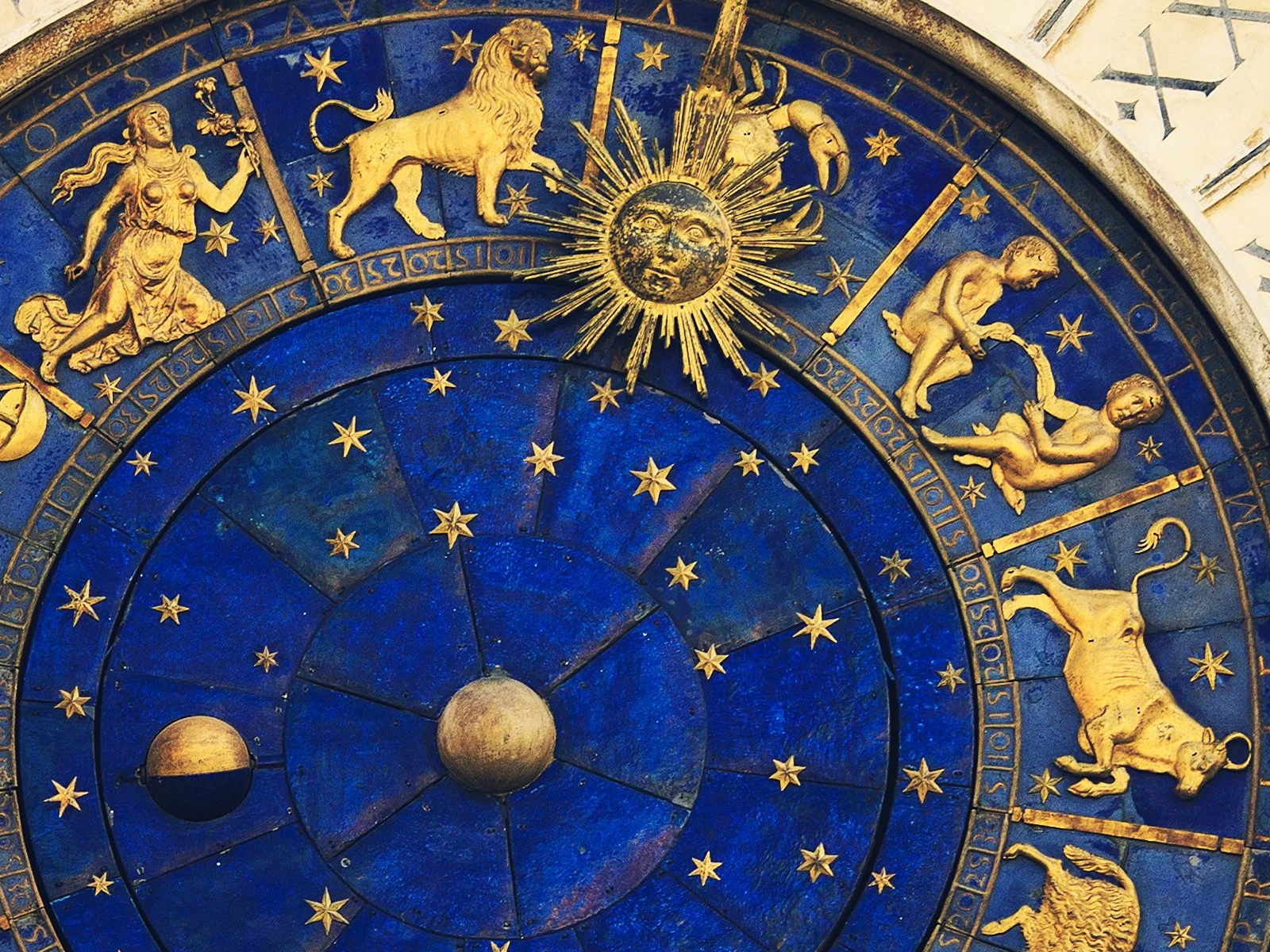 Blue and gold astrological zodiac clock with celestial symbols