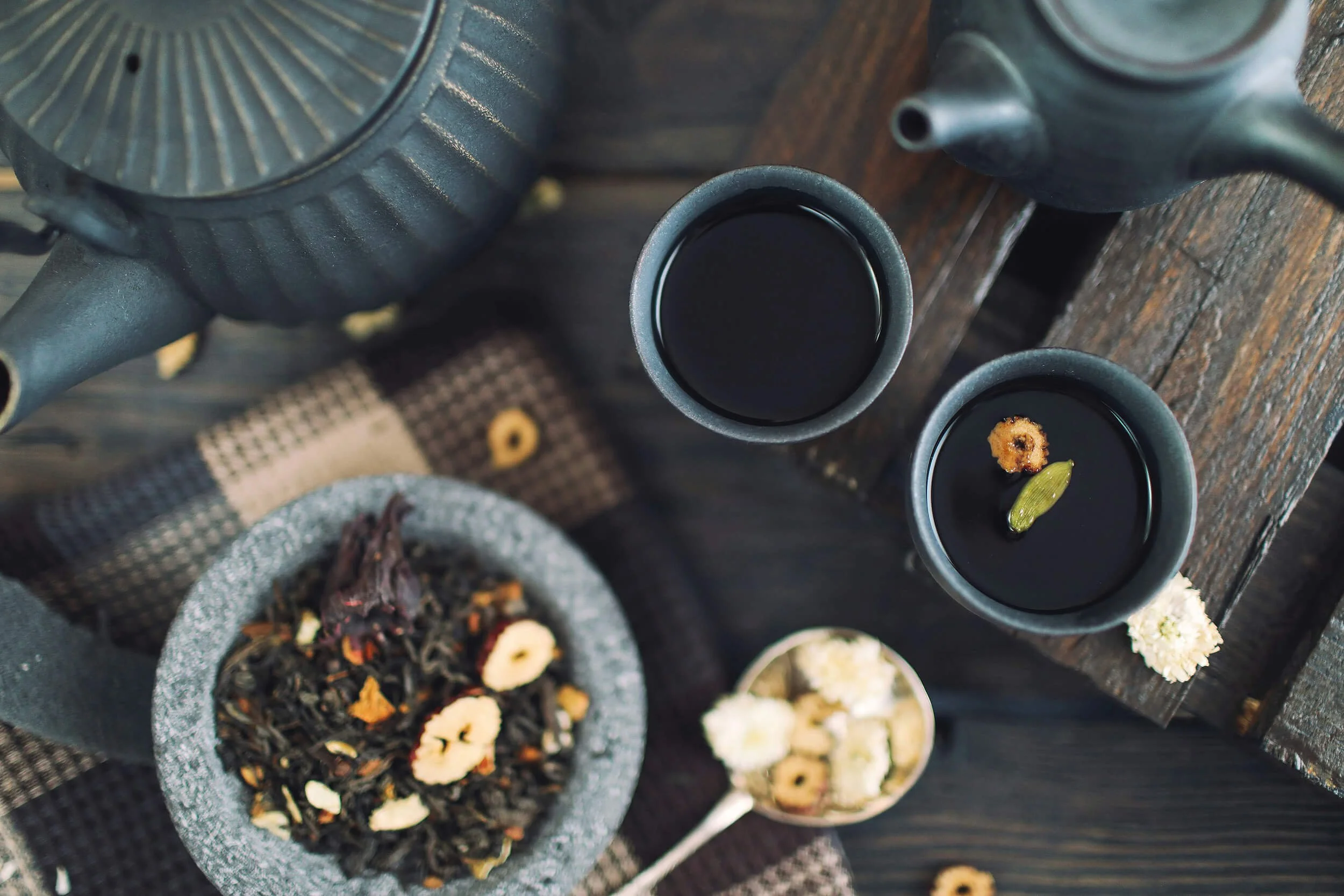 Top-down view of two small cups of herbal medicine as part of Traditional Chinese Medicine assessment at New Heights Acupuncture and Chinese Medicine in Houston, Texas.
