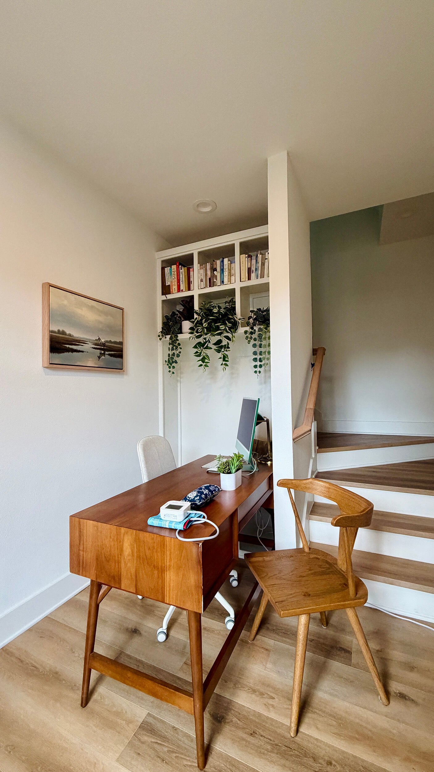A home office space with a wooden desk and two wooden chairs at New Heights Acupuncture and Chinese Medicine in Houston, Texas.