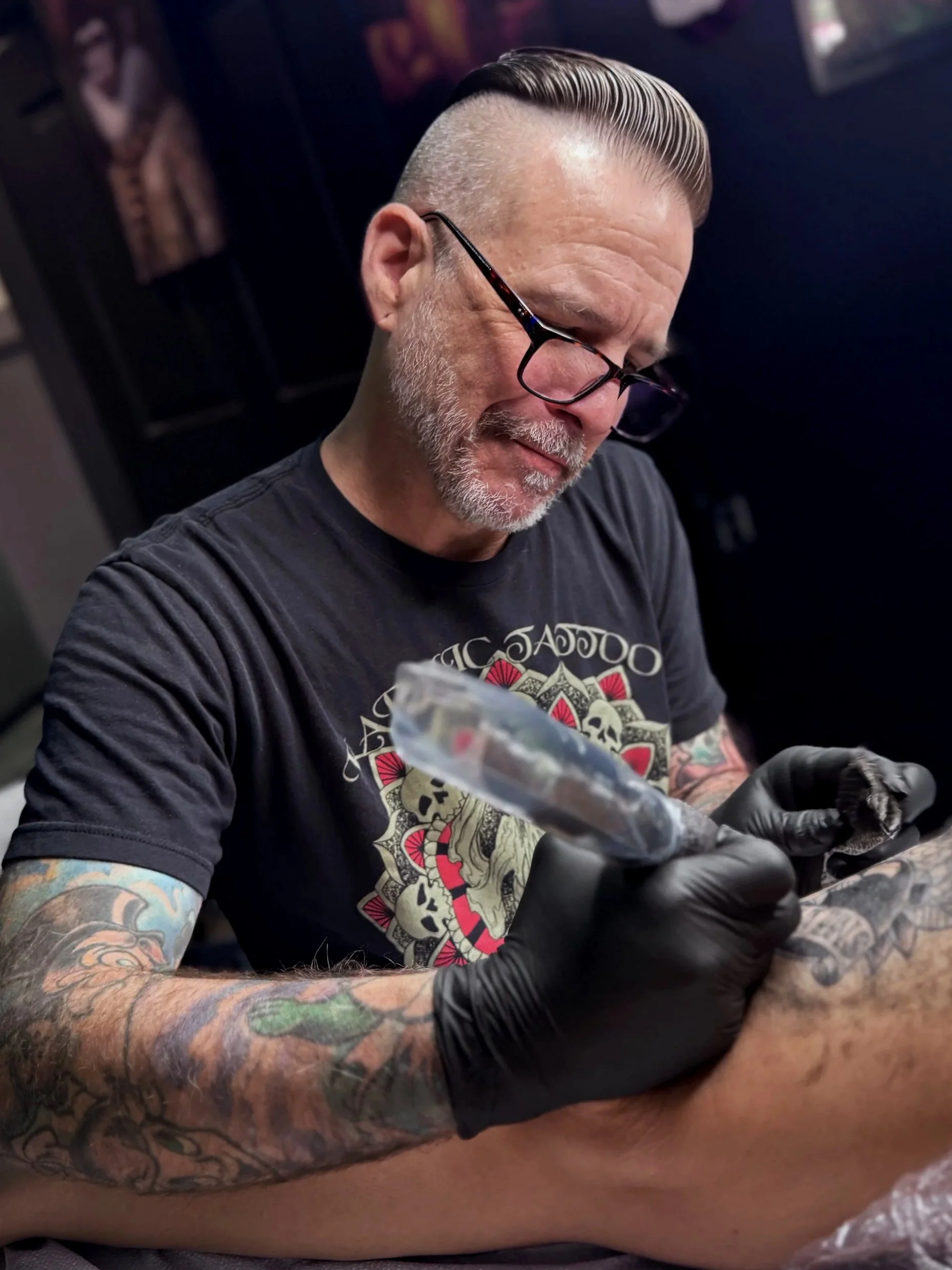 Jeremy Hulett, tattoo artist, performing the art of tattooing